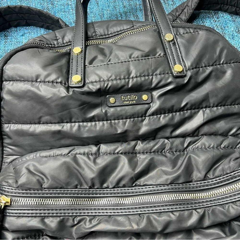 Tutilo Travel Backpack in Black with Gold Quilted Luggage Trolley Sleeve Pocket